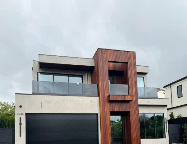 Modern hillside home exterior in dark paint