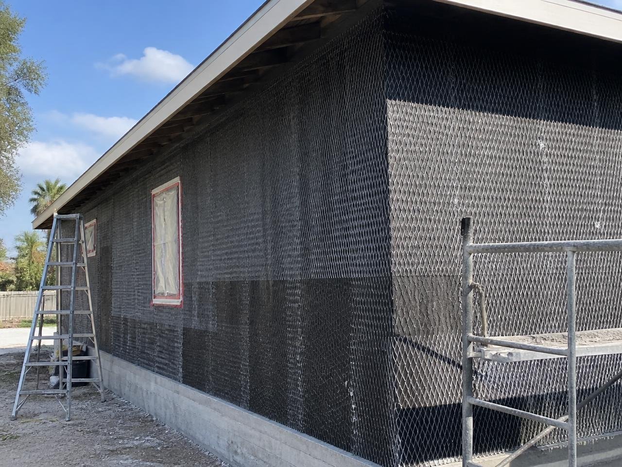 Exterior wall with building paper and wire lath installed before the scratch coat