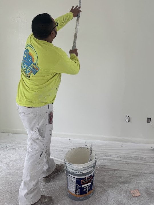Painter cutting in an interior wall by hand