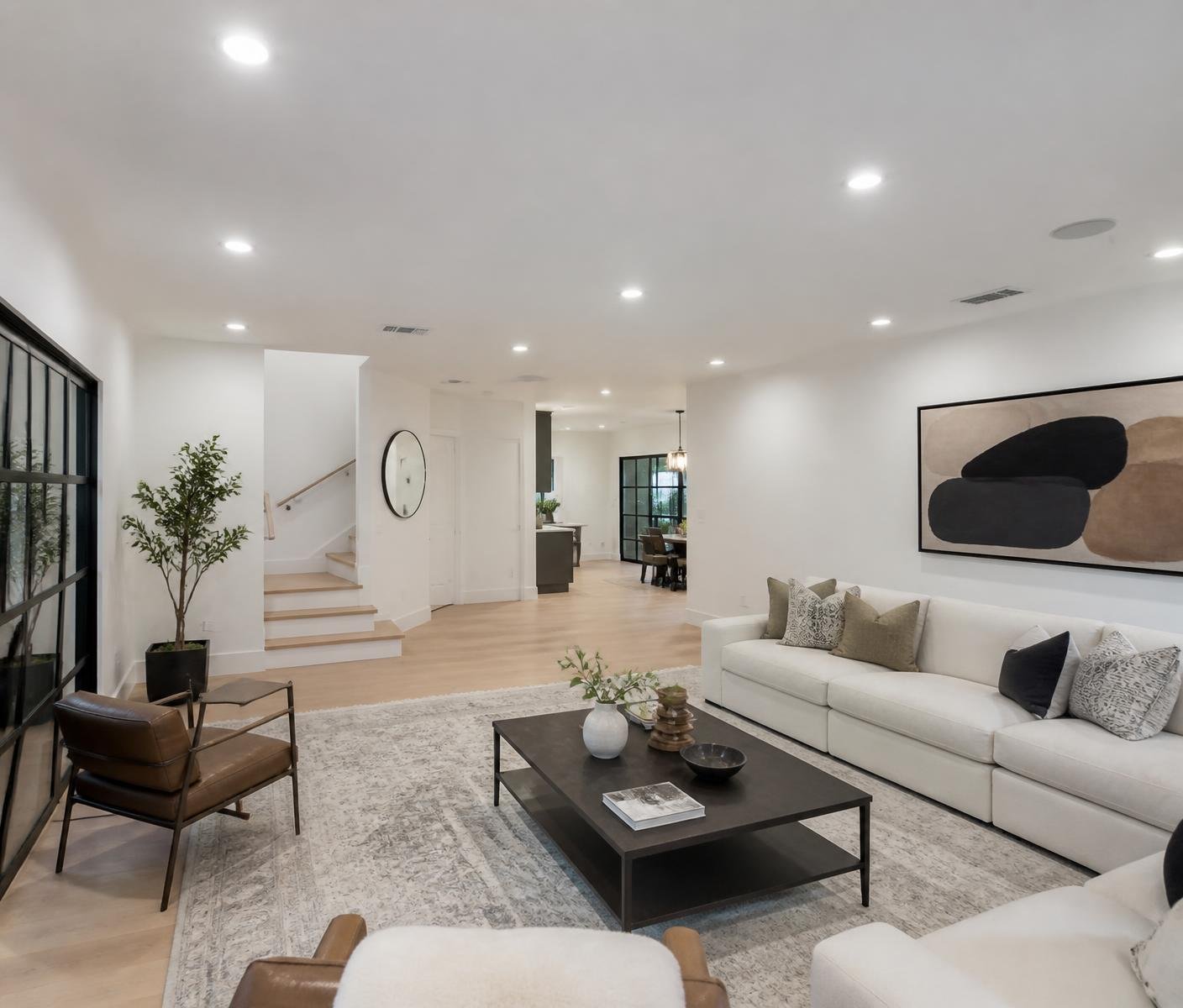 Bright living room with perfectly smooth painted white walls and ceiling under recessed lighting