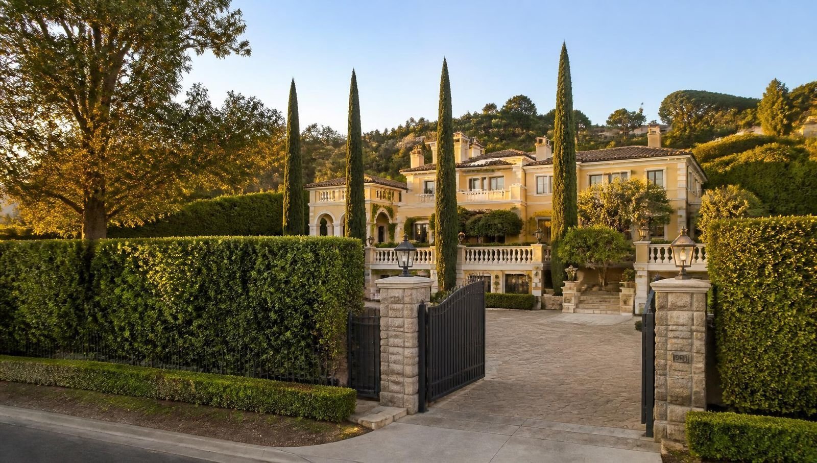 Gated Bel-Air estate with cream stucco walls and freshly painted white trim