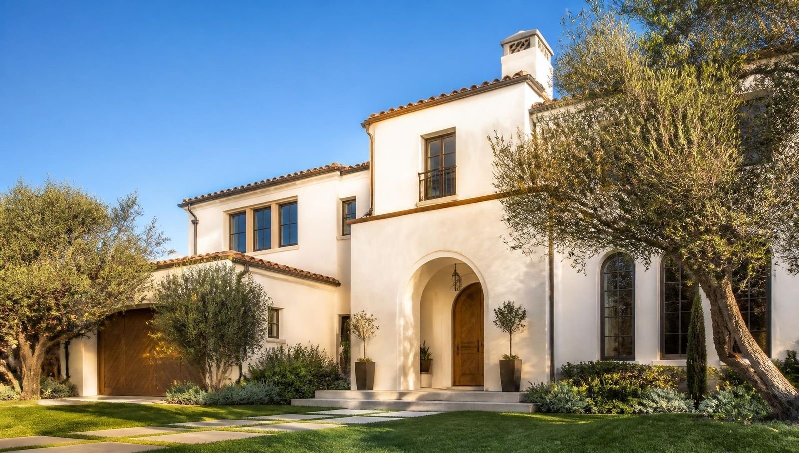 Mediterranean home in Santa Monica with smooth white stucco walls and a clay tile roof